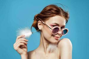 woman with fluffy earrings nude shoulders makeup clear skin photo