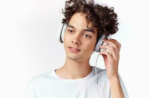 curly haired guy in headphones listening to music cropped view emotion photo