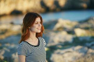 pretty woman in a striped t-shirt outdoors Summer sun mountains photo