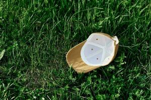 The sports cap lies on the fresh green grass photo