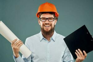 Cropped view of cheerful bearded man in orange paint in glasses with documents in hands photo