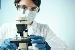 Woman in white coat laboratory science microscope analyzes photo