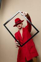 glamorous woman with wooden frame posing red suit studio model unaltered photo