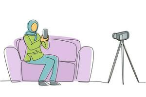 Continuous one line drawing Arab female influencer filming video review smartphone on dslr camera at home. Blogger advertising tech product, streaming live. Single line draw design vector illustration