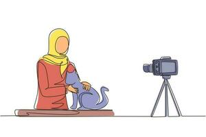 Single continuous line drawing Arabian vet blogger sitting in front of camera with cats and recording video blog about animals. Zoo psychologist creating content for vlog one line draw design vector