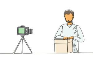 Single one line drawing Arab male vlogger unboxing, review product live on youtube in studio. Social media influencer recording unboxing video at home. Continuous line draw design vector illustration