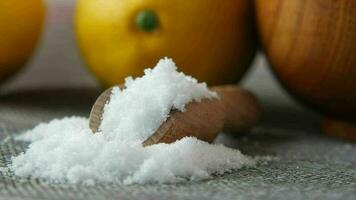 Coarse salt in a bowl and lemon on table video