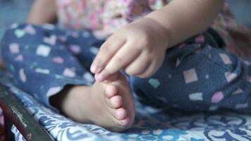 child girl touching foot In pain close up video