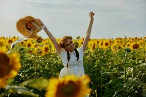 woman with pigtails In a field with blooming sunflowers unaltered photo