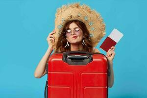 woman with red suitcase sitting on the floor passport and plane tickets lifestyle photo