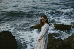 pretty woman with wet hair in white dress cliff photo