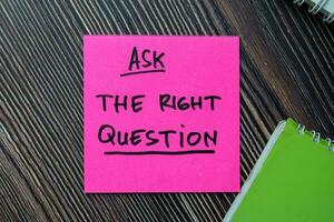 Ask The Right Question write on sticky notes isolated on office desk. photo