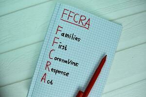 FFCRA - Families First Coronavirus Response Act write on a book isolated on office desk. photo