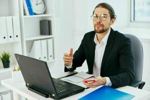 man in a suit work in the office in front of a laptop executive photo