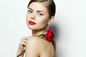 Young woman Red lips rose flower on shoulders attractive look photo