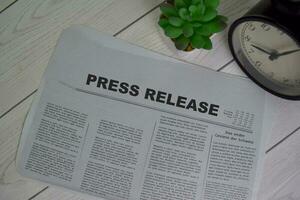 Press Release text in headline isolated on office desk. Newspaper concept photo