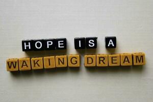 Hope is a Waking Dream on wooden blocks. Business and inspiration concept photo