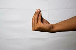 Close up Asian man shows hand gestures it means what are you talking about isolated on white background photo