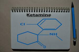 Ketamine write on a book. Structural chemical formula. Education concept photo