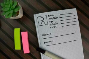 User's Persona write on a book isolated on wooden table. photo