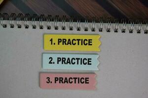 Practice write on sticky notes isolated on Wooden Table. photo