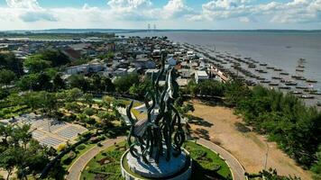 Aerial view of the A giant shark and crocodile statue as a symbol of the city of Surabaya. A landmark or monument as an icon of Surabaya city. East Java, Indonesia, August 28, 2022 photo