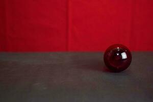 Close up lamp in red background and black table photo