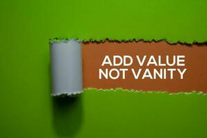 Add Value Not Vanity Text written in torn paper photo