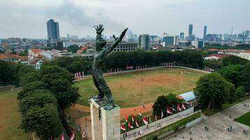 Aerial view of West Irian Liberation monument in downtown Jakarta with Jakarta cityscape. Jakarta, Indonesia, August 29, 2022 photo