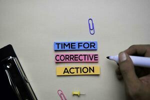 Time for Corrective Action text on sticky notes with office desk concept photo