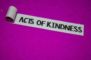 Acts of Kindness text, Inspiration and positive vibes concept on purple torn paper photo