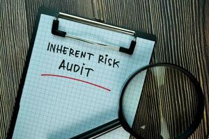 Inherent Risk Audit write on a paperwork isolated on Wooden Table. Business or Financial Concept photo