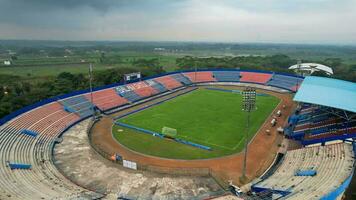 Aerial view of the Beautiful scenery of Kanjuruhan Stadium. with Malang cityscape background. Malang, Indonesia, August 26, 2022 photo