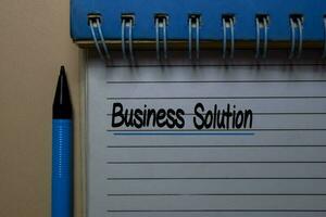 Business Solution write on a book isolated on office desk. photo