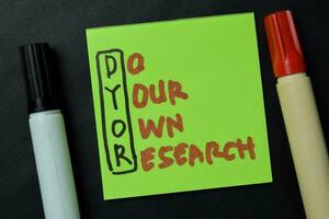 DYOR - Do your Own Research write on sticky notes isolated on office desk. photo