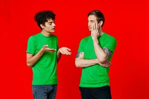 Cheerful friends Green t-shirt communication emotions red background photo