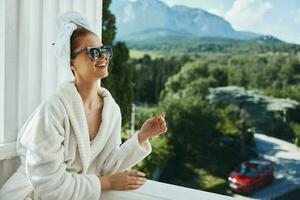 Portrait woman posing against the backdrop of mountains on the balcony architecture Relaxation concept photo