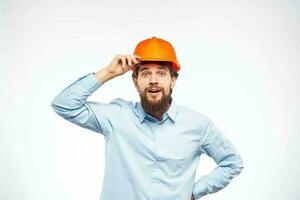 Engineer in orange coloring construction professional safety industry light background photo