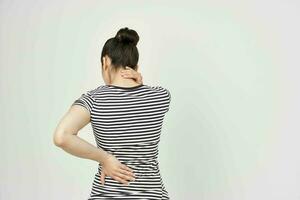 woman in a striped t-shirt pain in the neck health problems photo