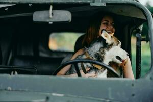 Woman and husky dog happily traveling in car smile with teeth fall walk with pet, travel with dog friend hugs and dances photo