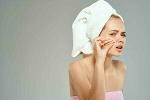 woman with towel on head naked shoulders face skin care health photo