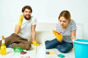 Young couple detergent washing the floor working together lifestyle photo