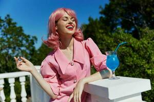 Young female with pink hair summer cocktail refreshing drink Relaxation concept photo