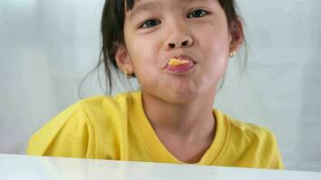 Cute little girl eating lollipop. Funny kid with lollipop candy. Child eating sweets. video