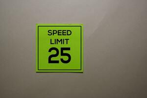 Speed Limit 25 write on a sticky note isolated on office desk. photo