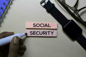 Social Security text on sticky notes isolated on office desk photo