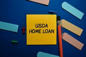 USDA Home Loan write on sticky note isolated on Office Desk. photo