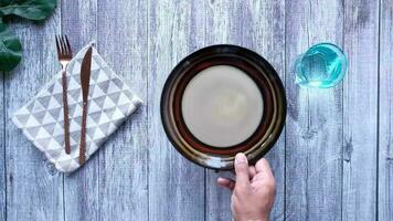 top view of person hand putting empty plate on table video