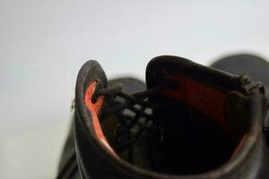 Close up of a brown old boots isolated on white background photo