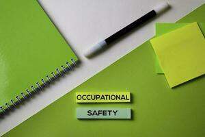 Occupational Safety text on top view office desk table of Business workplace and business objects. photo